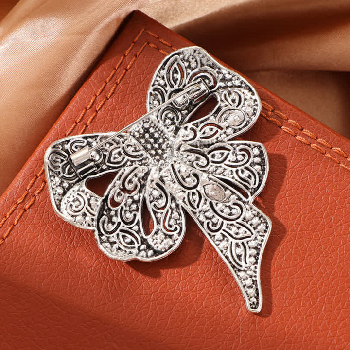 Damen-Brosche mit Strasssteinen in Antik-Silber mit Schleife und Knoten