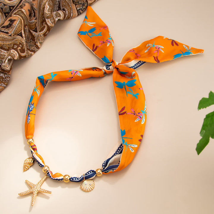 Halskette mit orangefarbenem Seestern-Muschel-Anhänger und Libellenmotiv - image 1